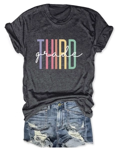 Detailed view of dark gray t-shirt with THIRD grade rainbow print and denim shorts
