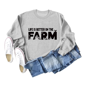 Detail of grey crewneck sweatshirt with Life Is Better On The Farm graphic and farm icons