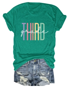 Detailed flat lay of a green T-shirt with Third Grade print and ripped denim shorts