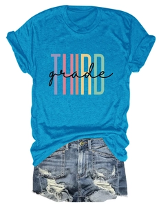 Detail of blue t-shirt with rainbow Third Grade text print and denim shorts