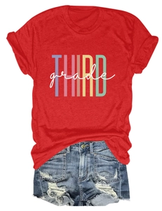 Flat lay of red T-shirt with Third Grade print and distressed blue denim shorts
