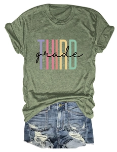 Detail of green Third Grade T-shirt paired with distressed denim shorts on white background