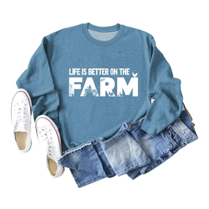 Flat lay of blue cotton sweatshirt with Life Is Better On The Farm farm-themed graphic