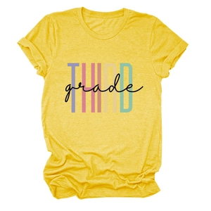 Close-up of vibrant yellow T-shirt with Third Grade letter print and rolled sleeves