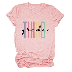 Detailed close-up of pink casual t-shirt with colorful Third Grade letter printing