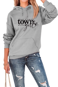 Detail van de hoodie met 'just a small TOWN girl' print en handige kangoeroezak vooraan