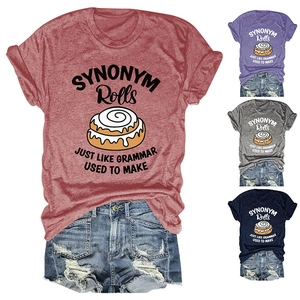 Detail view of cotton blend t-shirt fabric with fun cinnamon roll graphic and slogan