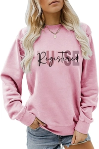 Detail of Registered NURSE lettering print on pink long-sleeve sweatshirt fabric