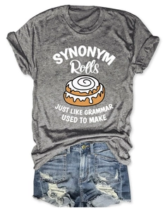 Detail of grey heather cotton T-shirt featuring funny cinnamon roll graphic and blue denim shorts