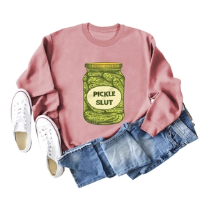 Flat lay detail of pink pickle slut sweatshirt with blue jeans and white canvas shoes