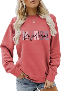 Detail of the Registered NURSE artistic print on a pink crewneck sweatshirt for women