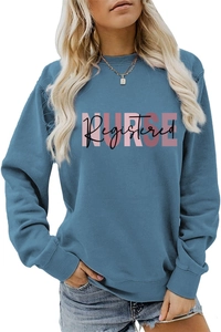 Close-up of pink NURSE and black Registered lettering on the blue long sleeve sweatshirt