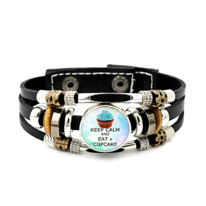 Detail of multi-layer leather bracelet with Keep Calm and Eat a Cupcake cupcake charm