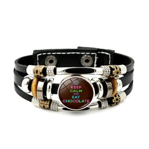 Detail of multi-layer leather bracelet with Keep Calm and Eat Chocolate glass charm