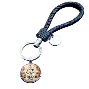 Keep Calm and Wonder On keychain with black braided leather rope and glass floral pendant