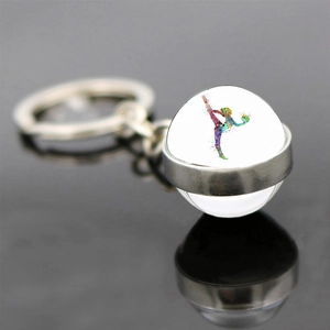 Macro shot of rhythmic gymnastics glass ball keychain with colorful athlete silhouette