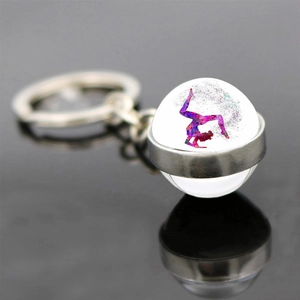 Artistic gymnastics keychain with colorful watercolor silhouette inside glass ball pendant