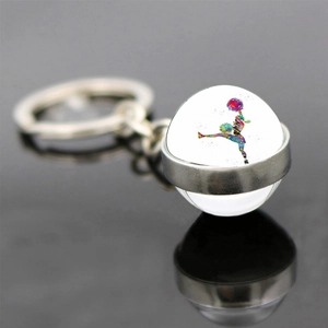 Macro shot of rhythmic gymnastics keychain featuring a double-sided glass ball pendant