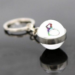 Macro view of double-sided glass pendant with colorful rhythmic gymnast silhouette
