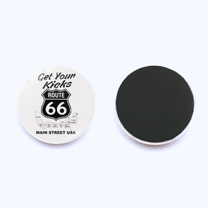 Close-up of Route 66 glass fridge magnet showing the front design and black magnetic back