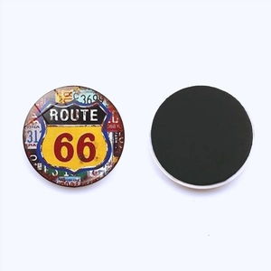 Close-up of circular Route 66 fridge magnet showing vintage design and magnetic back