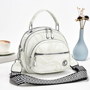 Elegant off-white marble pattern handbag with chevron strap and silver hardware accents