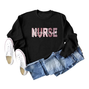 Flat lay of black sweatshirt with pink Nurse Registered print and casual denim jeans