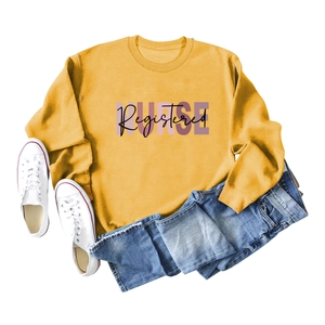 Flat lay of a yellow Registered Nurse sweatshirt with blue jeans and white sneakers