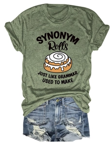 Flat lay of army green T-shirt with cinnamon roll print and frayed denim shorts