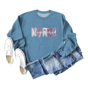 Blue Registered Nurse crewneck sweatshirt styled with denim shorts and white sneakers