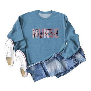 Flat lay of foggy blue long sleeve sweatshirt featuring Registered NURSE lettering design