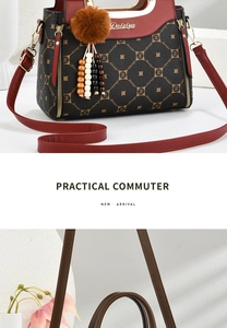 Detail of elegant shoulder strap and textured monogram leather on a commuter handbag