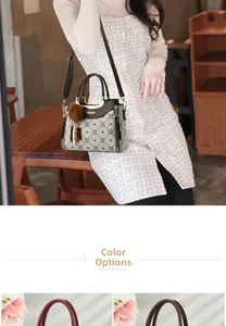 Detail view of printed crossbody bag with faux fur pompom and adjustable shoulder straps