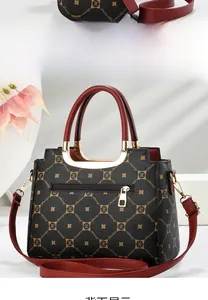 Detail view of vintage monogram patterned leather handbag with gold metal hardware