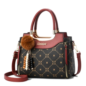 Fashionable monogram handbag for women featuring dark pattern and red leather details