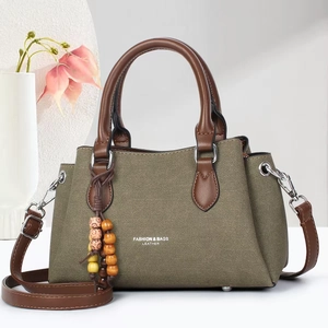 Fashion army green canvas tote bag with brown leather handles and adjustable strap
