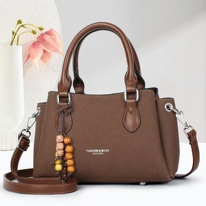 Brown lychee grain leather tote bag with top handles and adjustable strap for women