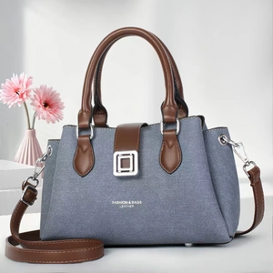 Chic grey-blue tote bag with brown leather handles and adjustable shoulder strap for women