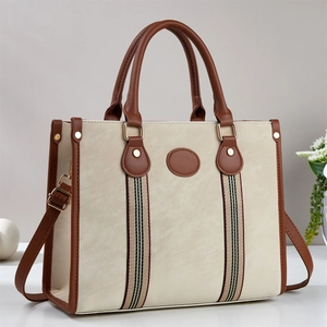 Minimalist beige tote bag with brown handles and classic tricolor striped webbing detail