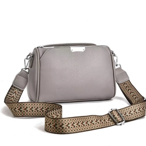 Grey pebbled leather crossbody bag with ethnic jacquard wide strap and silver hardware