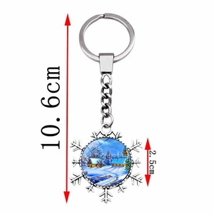 Detailed view of snowflake keychain with dimensions: 10.6cm length and 2.5cm round winter scene
