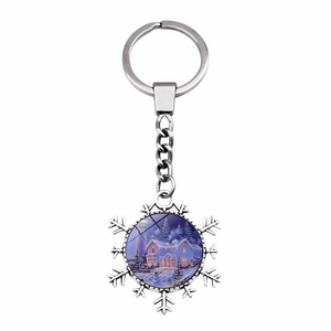 Detail of snowflake keychain featuring a winter snow house painting on silver metal charm