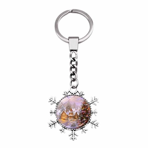 Christmas snowflake keychain with a cozy winter snow cabin and tree scene illustration