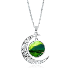 Detailed view of silver hollow moon pendant with Aurora Borealis glass stone on a cable chain