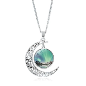 Detailed view of moon pendant with aurora landscape and silver hollow frame on white base