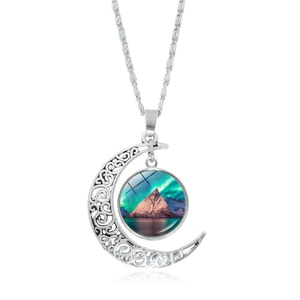 Macro detail of silver crescent moon necklace with northern lights aurora glass pendant