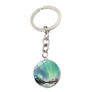 Detailed view of silver keychain with a round glass aurora landscape pendant