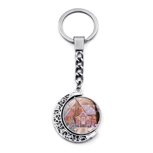 Détail du porte-clés rotatif croissant de lune avec illustration maison sous neige
