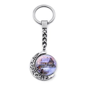 Porte-clés lune argentée rotatif avec motif de maison sous la neige pour cadeau de Noël