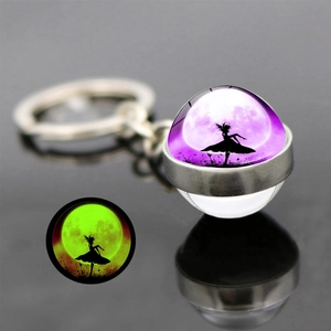 Glow-in-the-dark butterfly fairy glass ball keychain glowing in green light